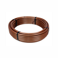 Coiled Rain Bird XFCV 0.6 GPH brown drip tubing (500 ft) showing tubing profile and model label XFCV0618500.