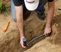 Installed-location photo of Irritrol Super Blue Flex swing pipe routing to a spray head, demonstrating flexibility and placement in landscape.