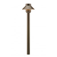 Front view of FX Luminaire SP-A aluminum path light in bronze metallic finish mounted on a 12-inch riser with ground spike.